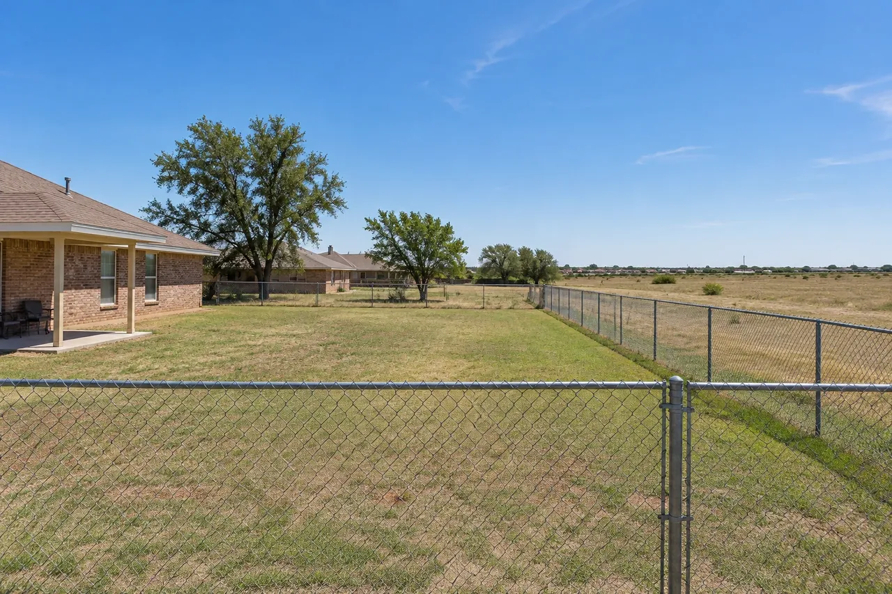 Galvanized chain link fence around a large backyard outside Lubbock
