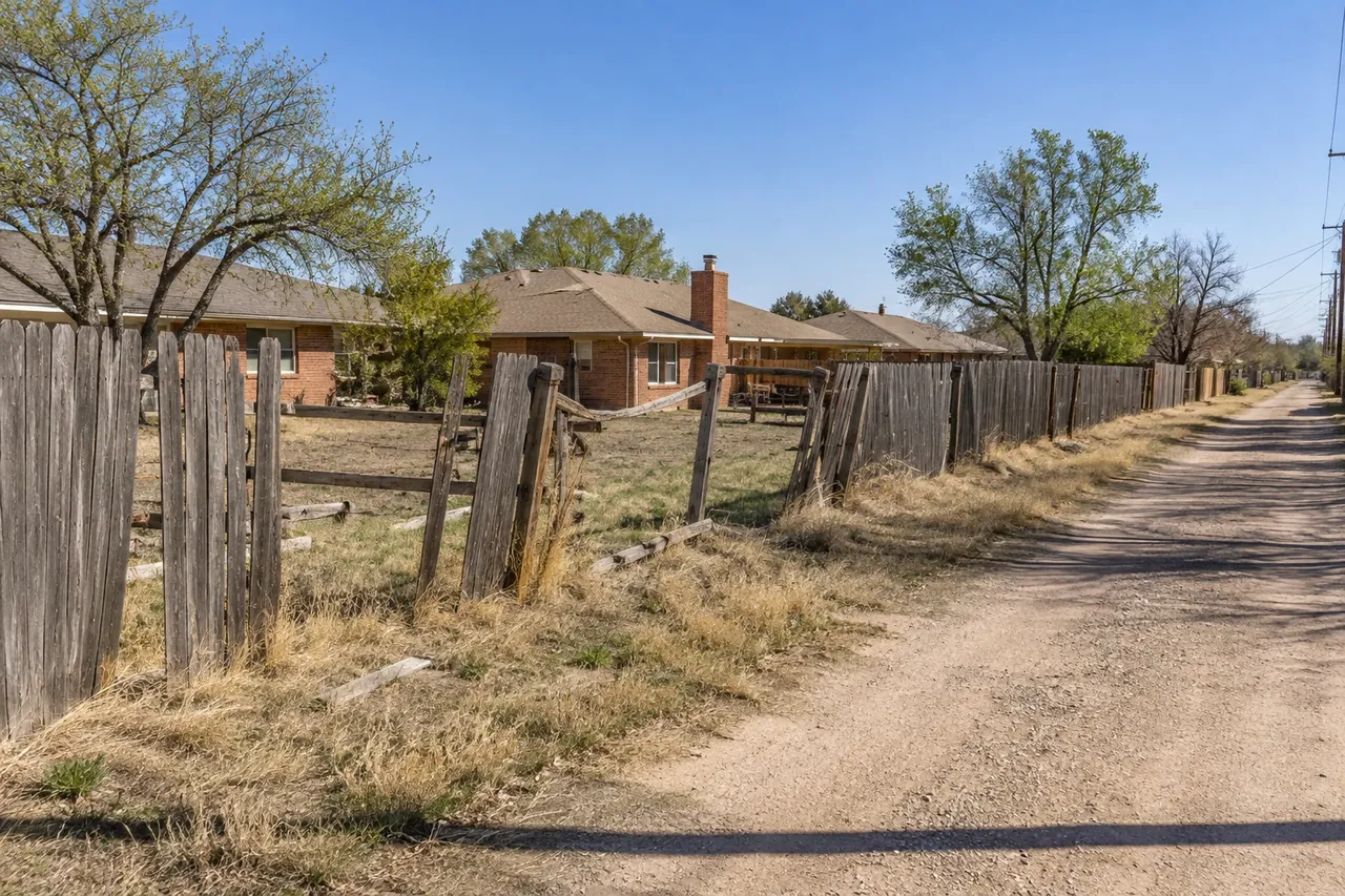 Old gray wood fence with leaning posts along a Lubbock alley